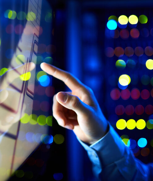 Engineer working on computer analyzing technical data for business IT solutions implementation